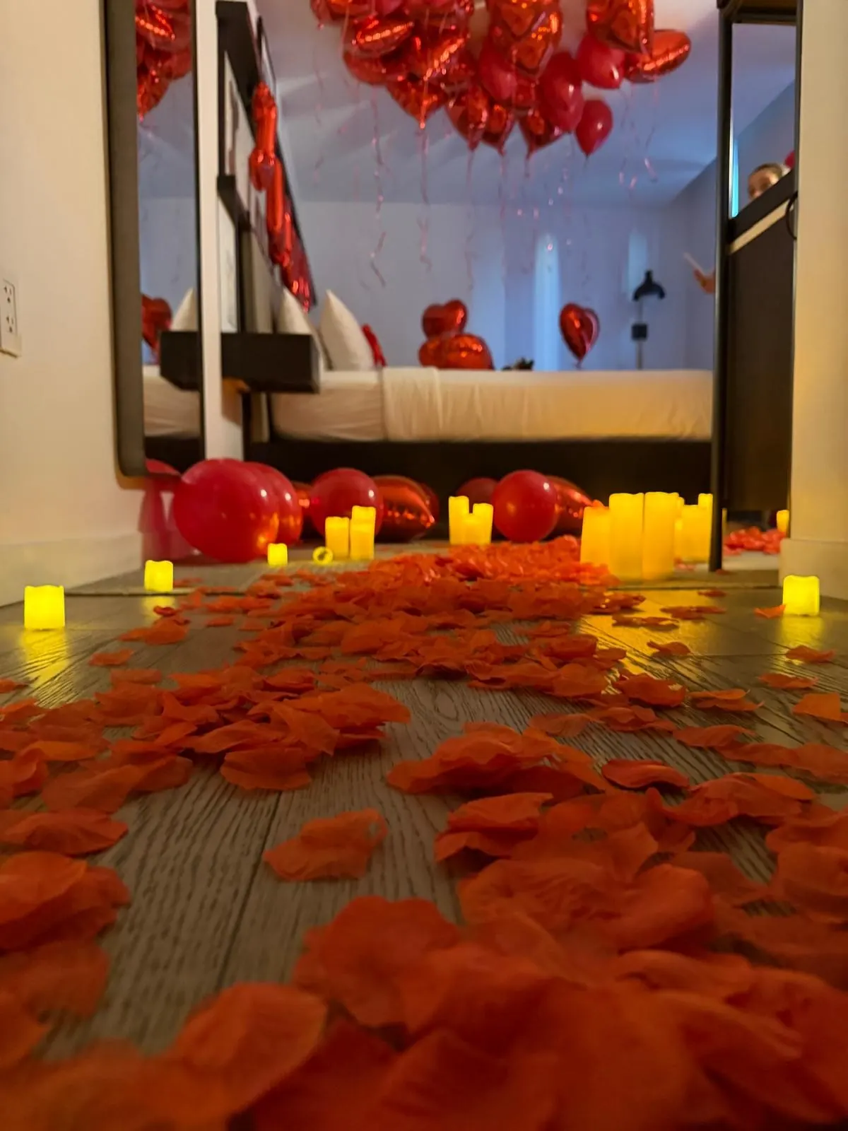 Candlelit rose-petal path in a hotel suite