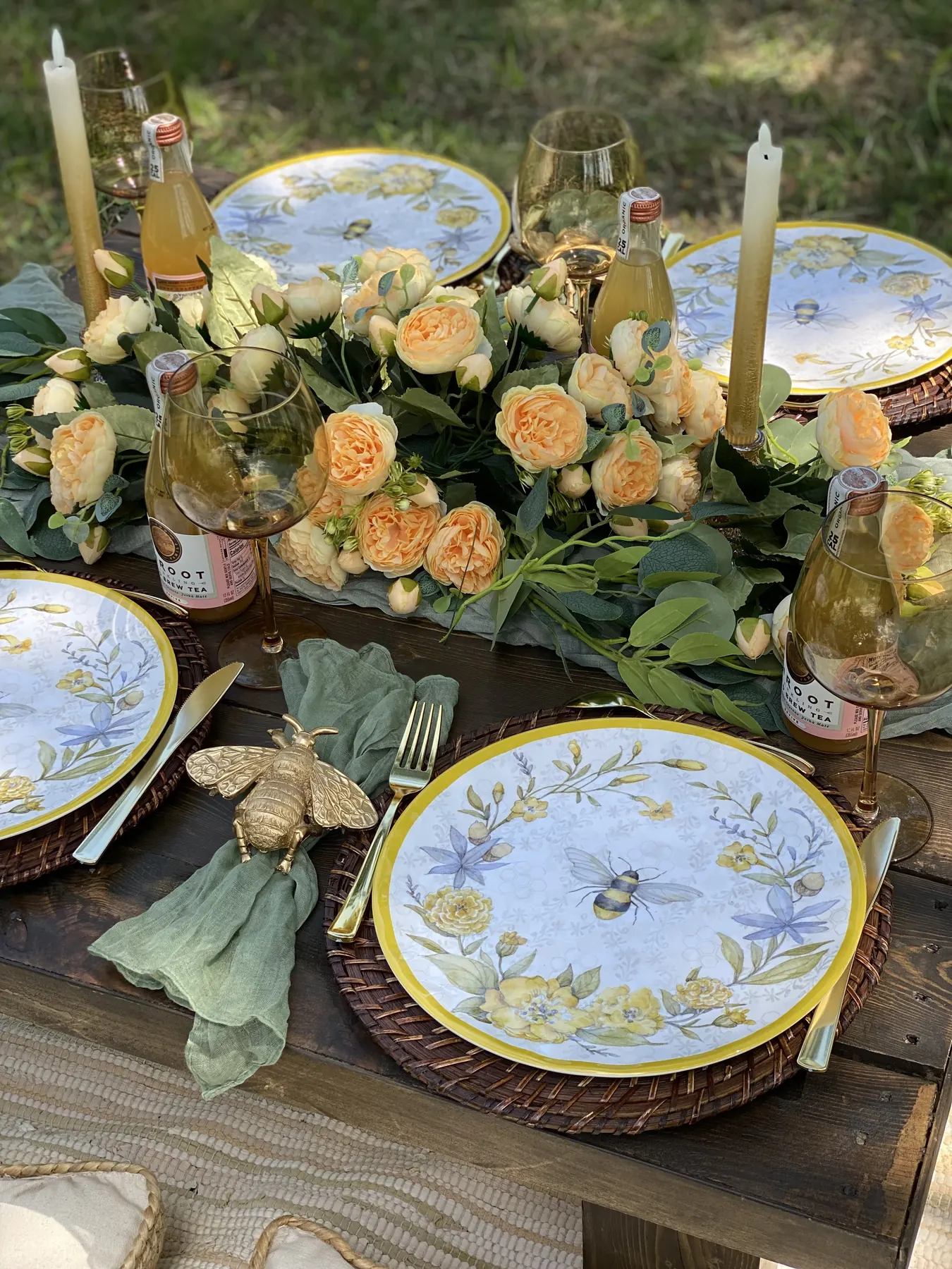Garden picnic with peach roses and bee plates